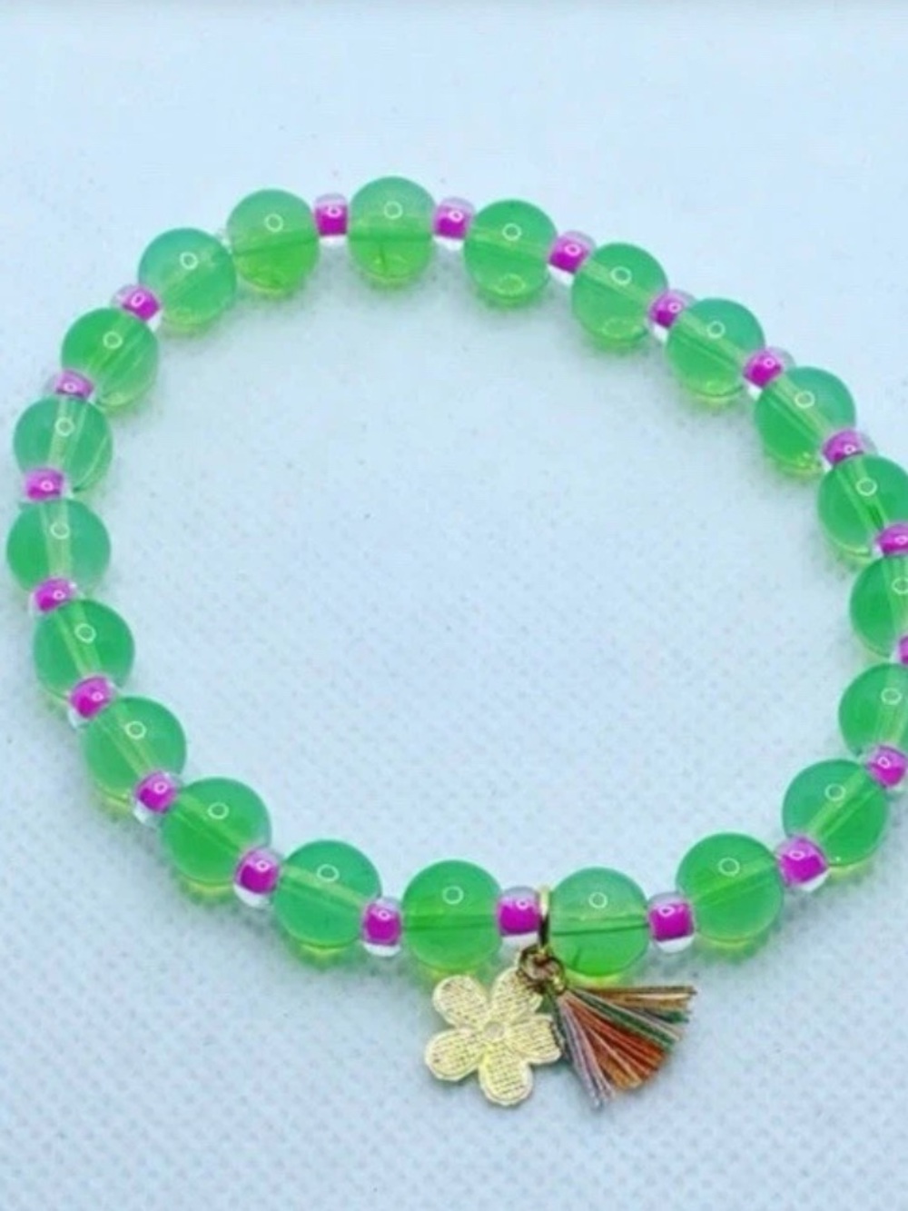 Green Beaded Stretch Bracelet with Flower Charm and Tassel